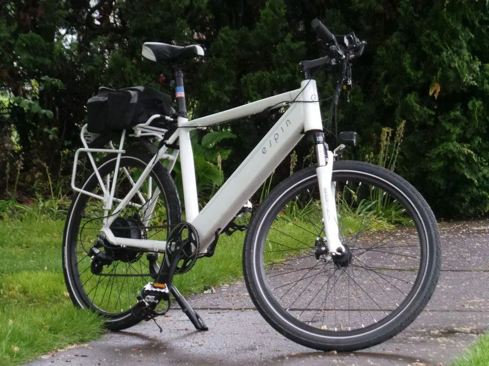 Bicicleta eléctrica blanca aparcada en un sendero