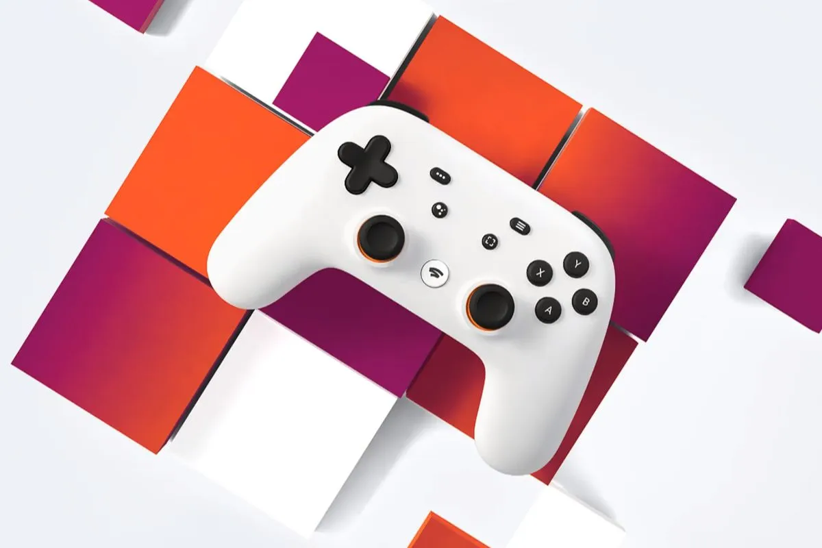 Mando de videojuegos blanco sobre fondo rojo con formas geométricas